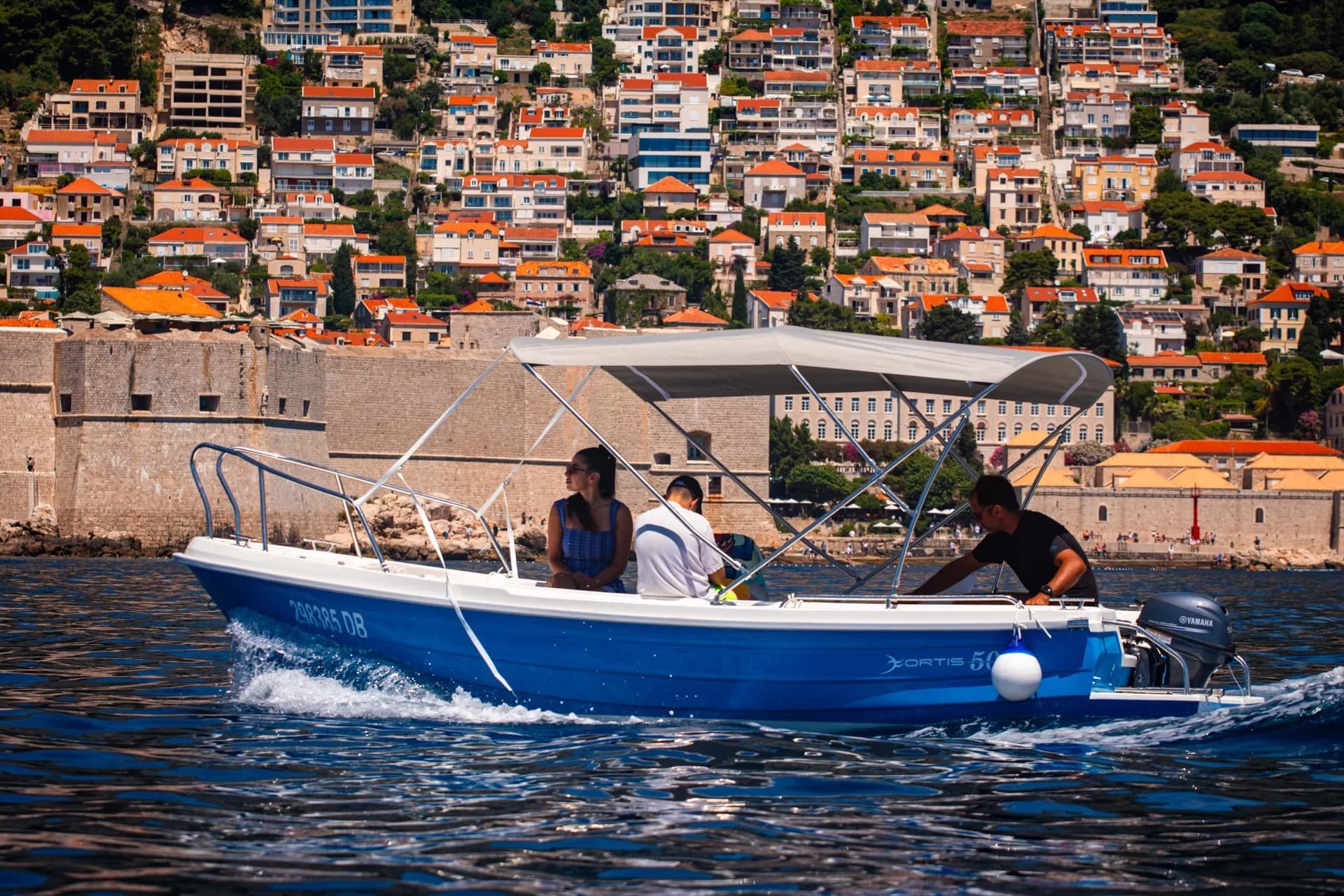 Boat passing beneath Dubrovnik Old Town walls
